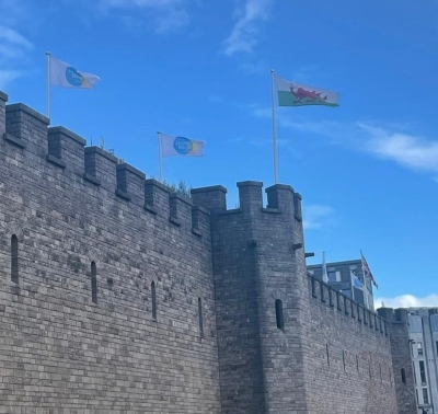 Living Wage Foundation and Wales flags flying over Cardiff Castle