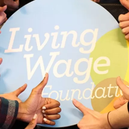 Living Wage Foundation logo surrounded by thumbs up