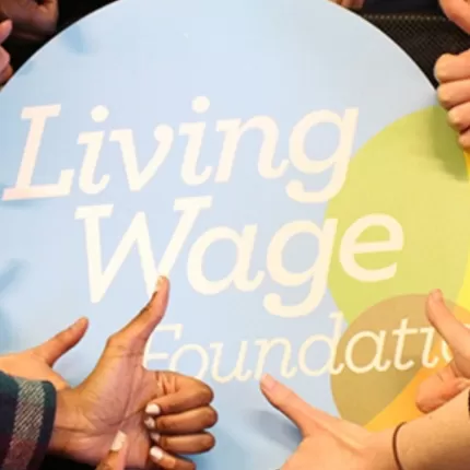 Living Wage Foundation Logo Surrounded by 'Thumbs Up'